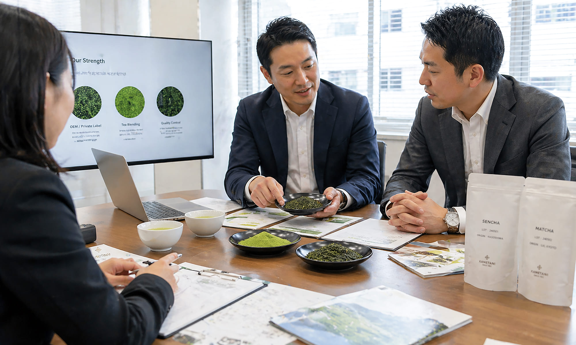 A professional business meeting scene focused on partnership in the food and beverage industry, featuring two or more professionals reviewing tea samples and documents on a table, subtle presence of Japanese green tea (leaves or powder), clean and modern office environment, natural lighting, realistic, B2B atmosphere, no luxury or ceremonial elements