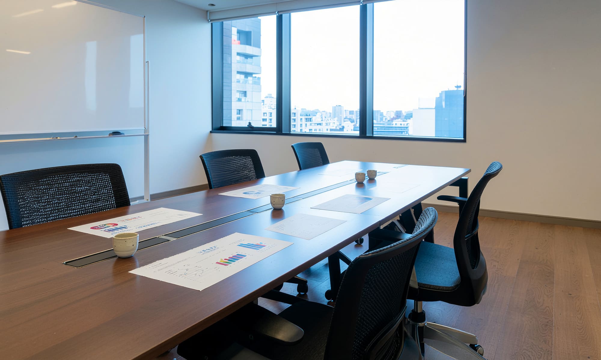 Food product developers discussing ingredients in a modern workspace, tea samples and documents on table, collaborative environment, realistic, B2B tone