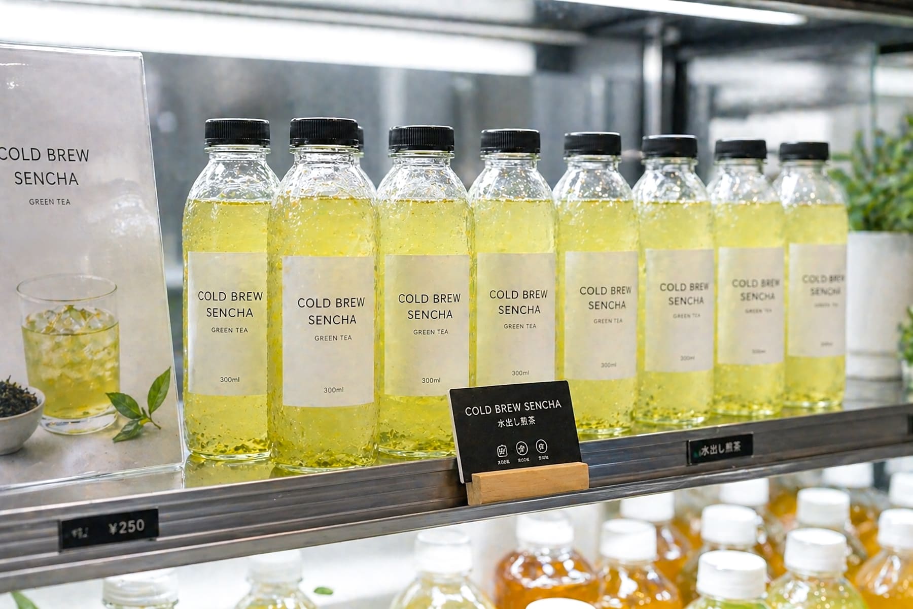 A lineup of ready-to-drink cold brew sencha bottles displayed in a retail or product showcase environment, modern packaging, clean branding style, realistic, B2B market context
